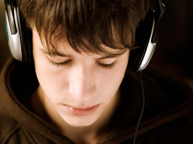 male teen wearing headphones