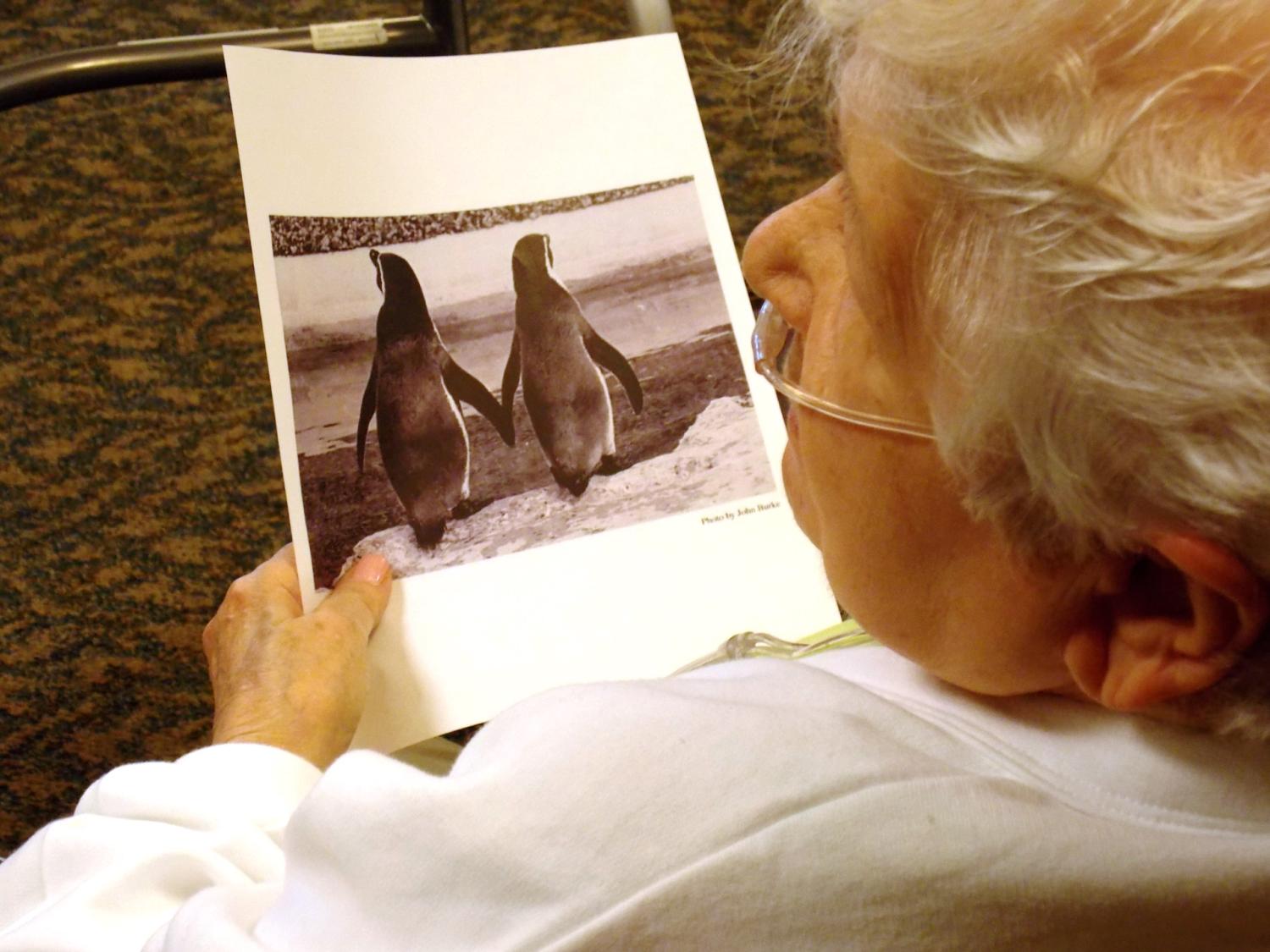 A woman looks at a picture.