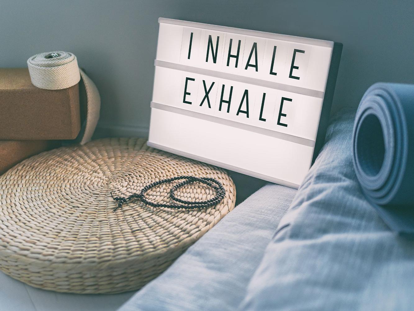 yoga equipment accompanied with a sign that says inhale exhale
