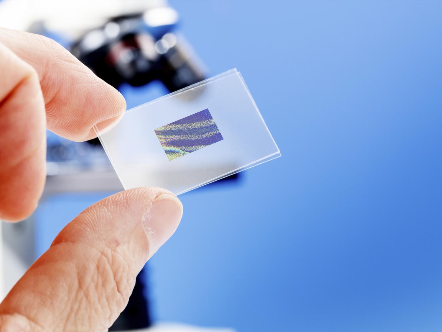 computer chip with microscope in background