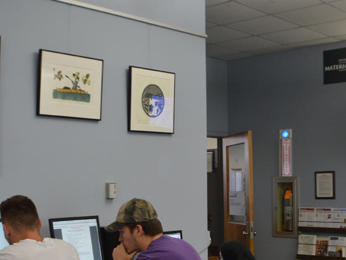 inuit art exhibit on wall of EMS library