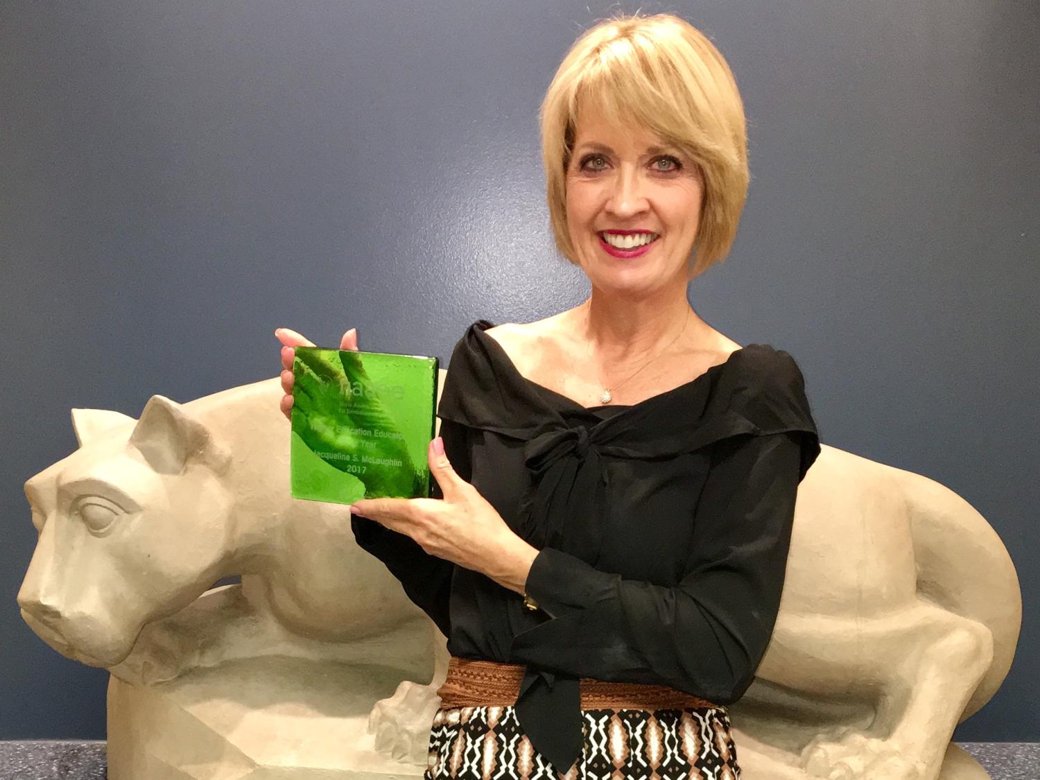 Professor McLaughlin holding her award