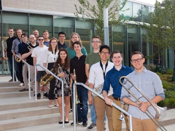 members of the Centre Dimensions jazz ensemble pose for a photo outside of a building