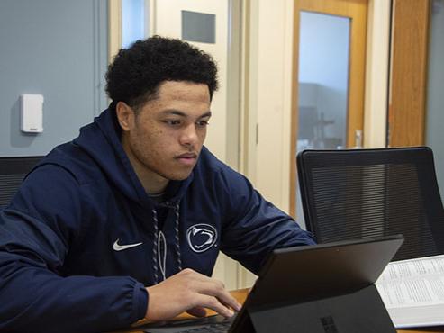 A student works on his laptop