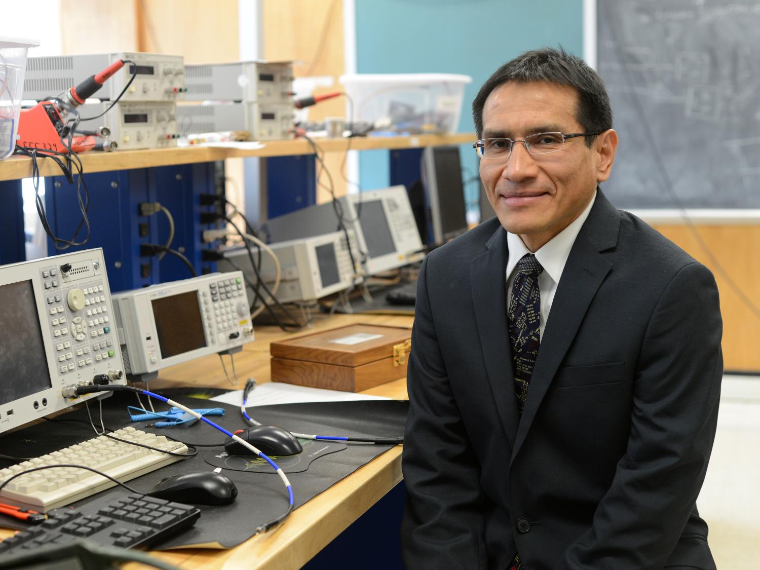 Julio Urbina sitting in lab