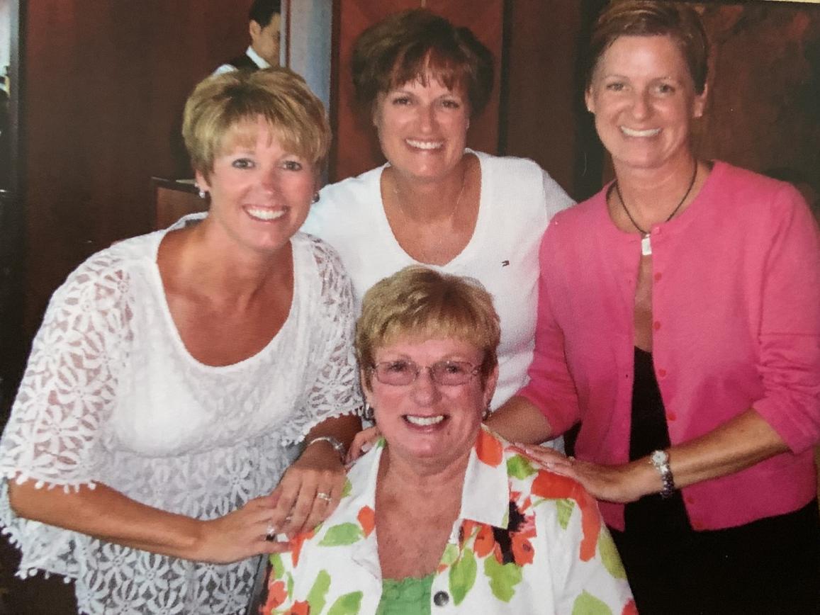 Four women stand together in a family photo