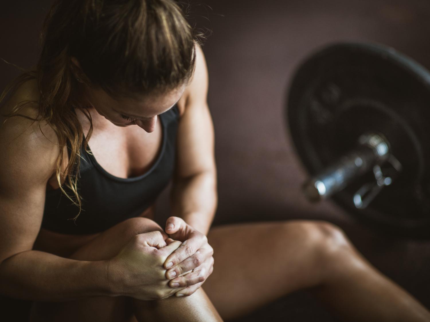 woman holding her knee