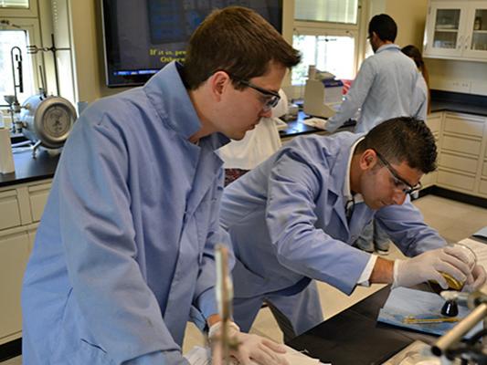 Graduate Students Working in Baker Hughes Production Laboratory