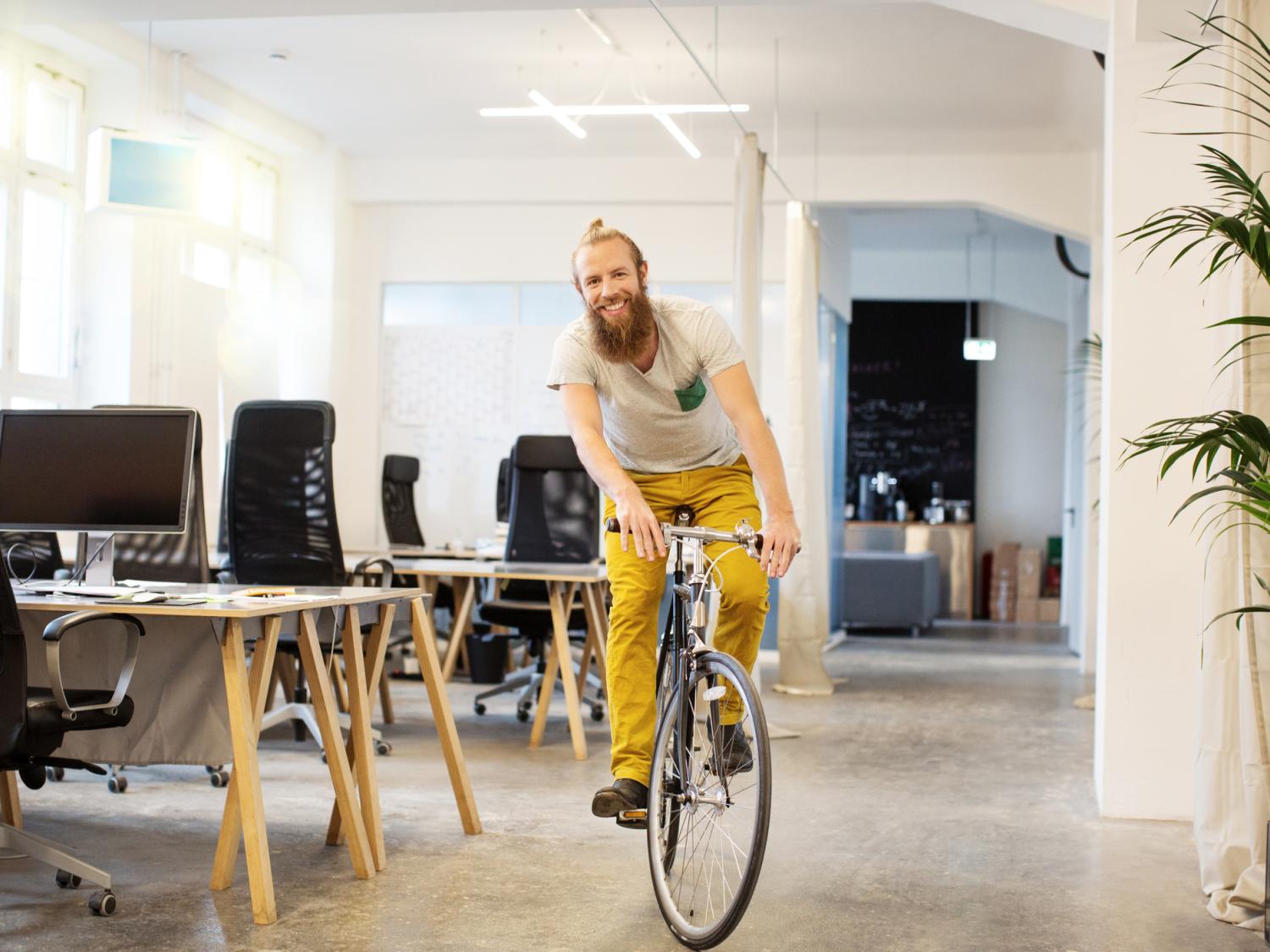 man riding bike in office