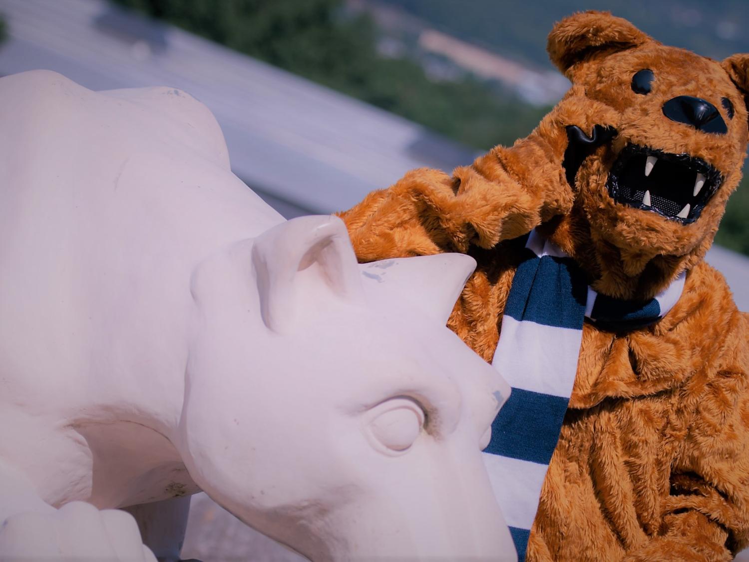 The Nittany Lion standing next to Nittany Lion Shrine