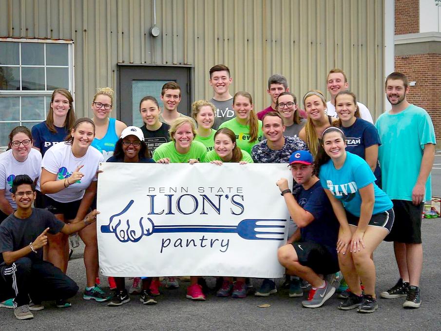 Group of Lion's Pantry students holding a banner