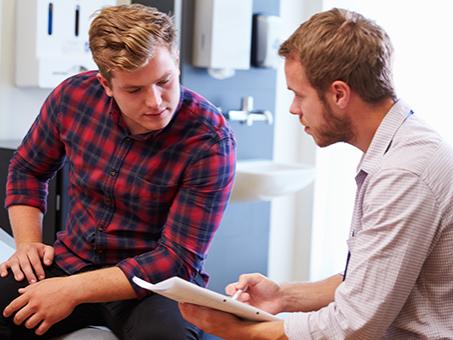 A man and his doctor talk.