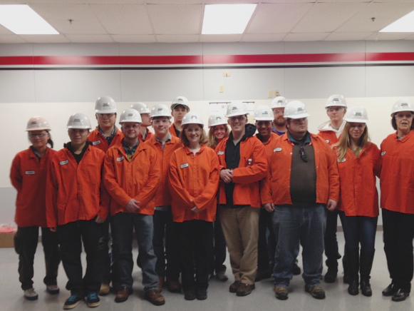 group photo of students wearing hardhats in a steel plant