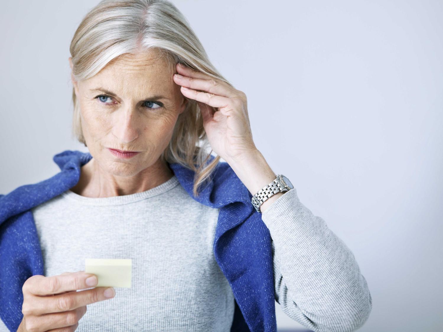 older woman with hand on forehead