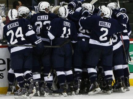 The Penn State men's hockey team huddles to celebrate a goal