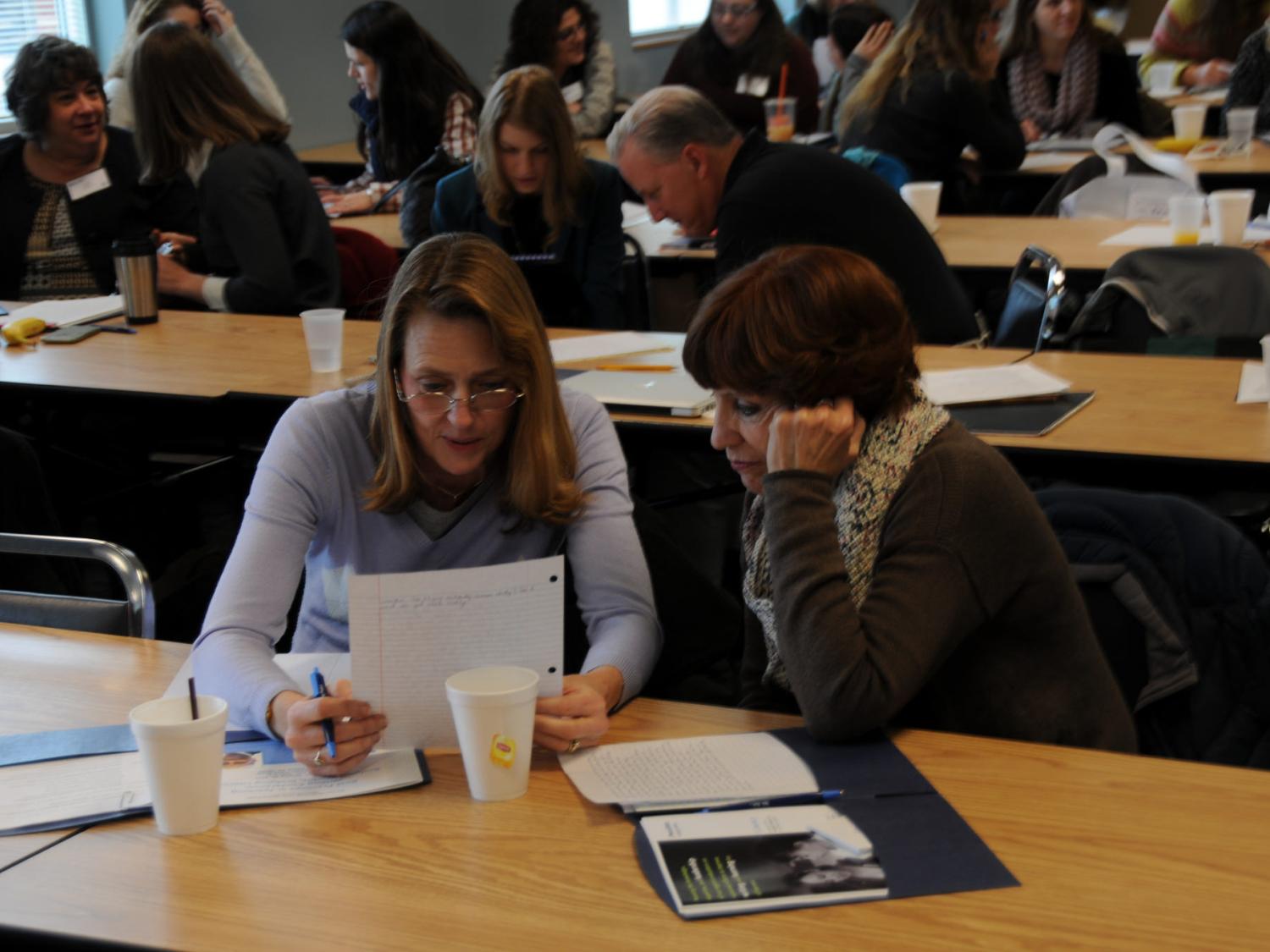 Women reading an assignment together