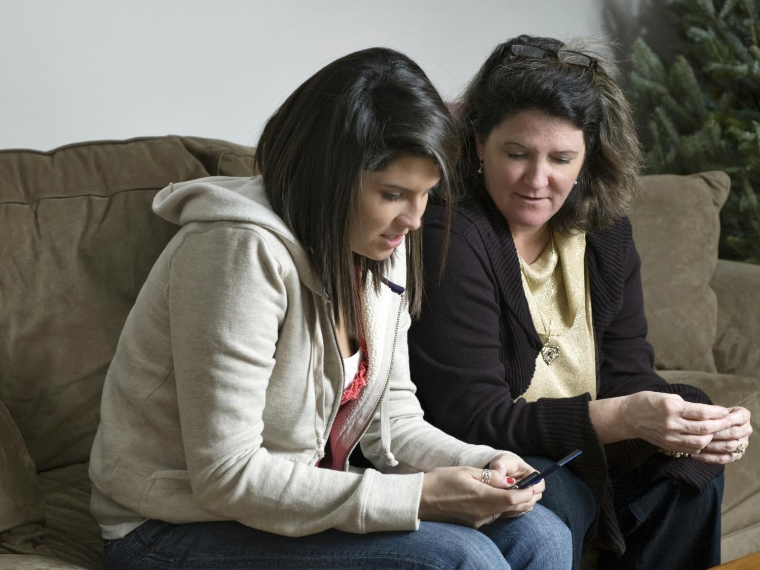 teen and mother sitting next to each other