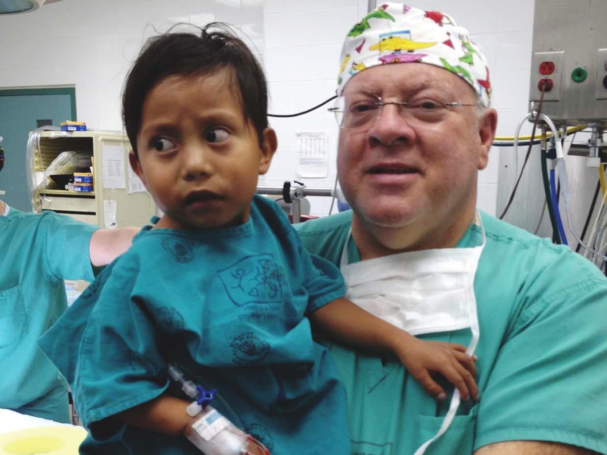 Dr. Jack Myers with a young patient in Ecuador