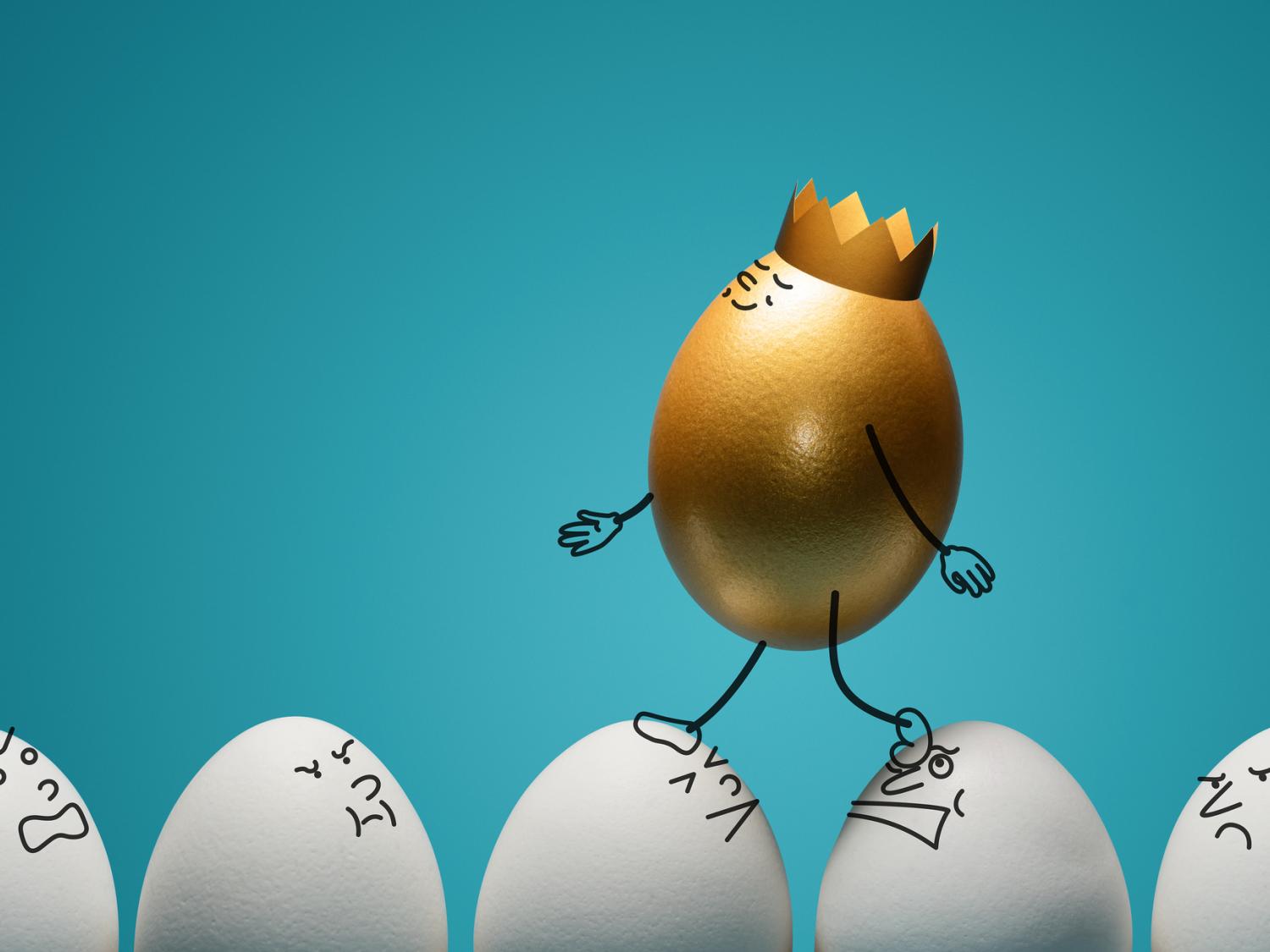 A golden egg with a crown walking onto of other white eggs