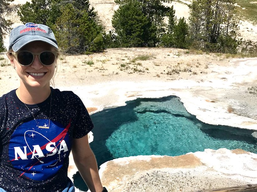 Rachel Kronyak poses next to a hot spring in Yellowstone National Park 