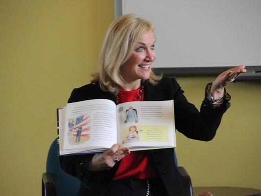 Woman reading a book at public event