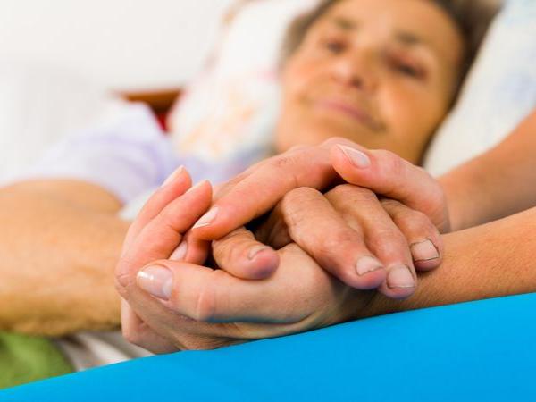 Nurse holding a patient's hand