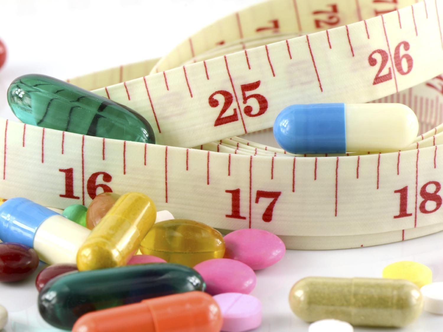pills and tape measure