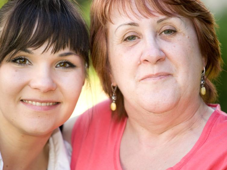 older mom proud of adult daughter