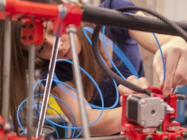 Valerie Miller works on a 3-D printer