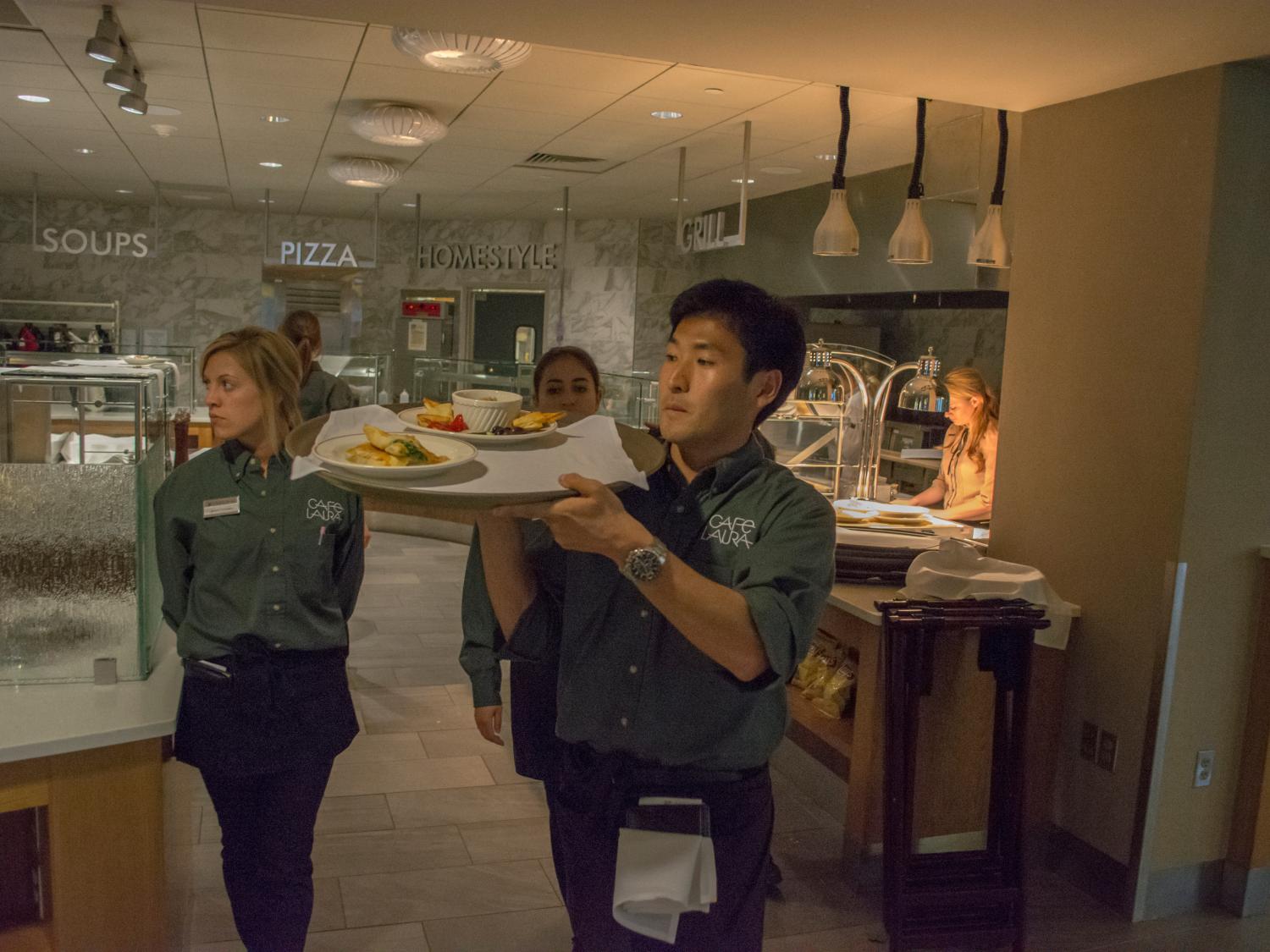 Student serves meal at Cafe Laura
