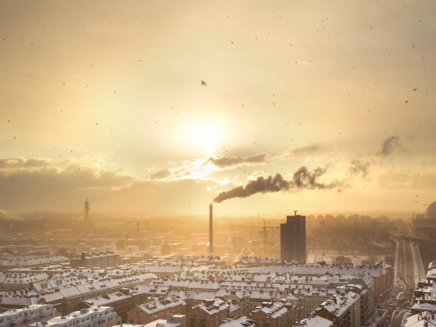 An industrial cityscape of a town filled with factories and air pollution at sunset. Photo by Petter Rudwall on Unsplash