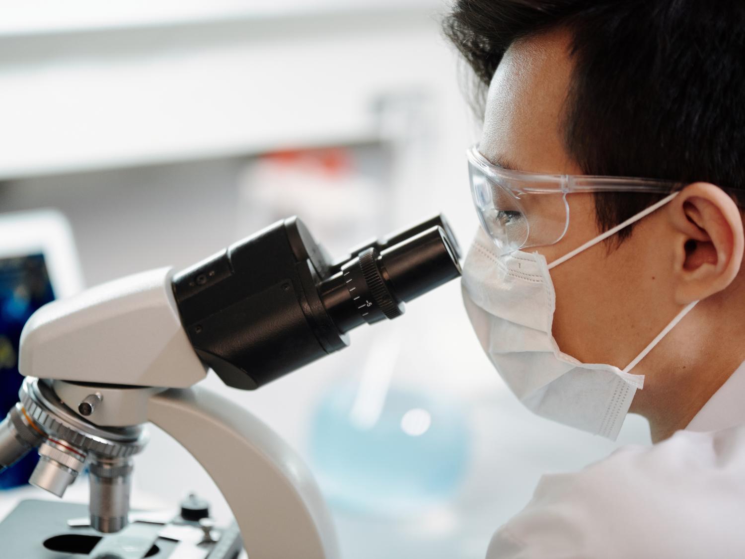 Man looking into microscope