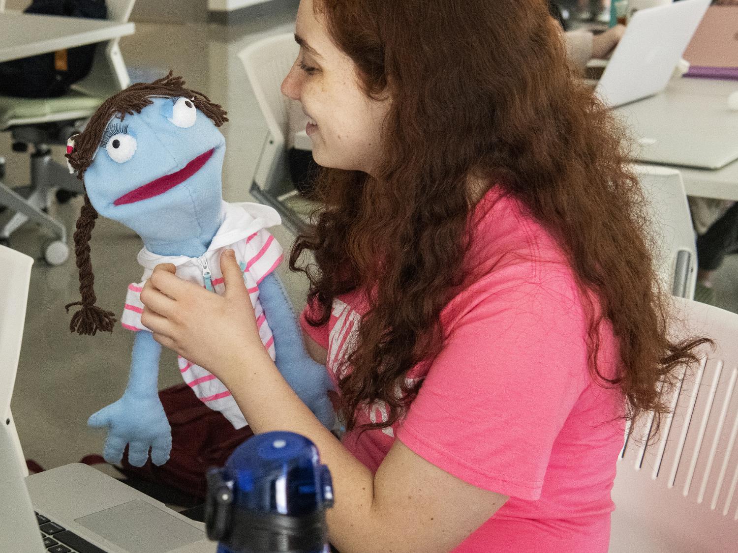 student making puppet