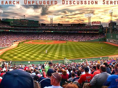 crowd watching baseball game at dusk