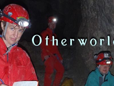 inside of cave with inset photo of two women and one man exploring cave with jumpsuits and lighted helmets