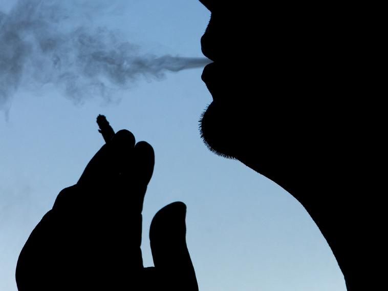 silhouette of man smoking