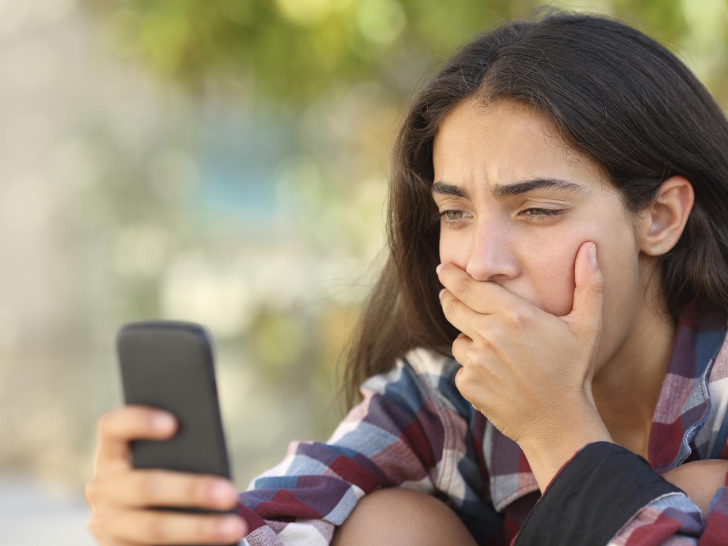 shocked teen looking at phone
