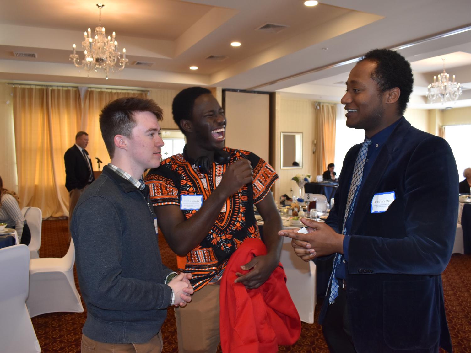 Carlos Jeremie, at right, talks with fellow scholarship recipients Stanley Igbudu, center, and Jacob Butterfuss, left.