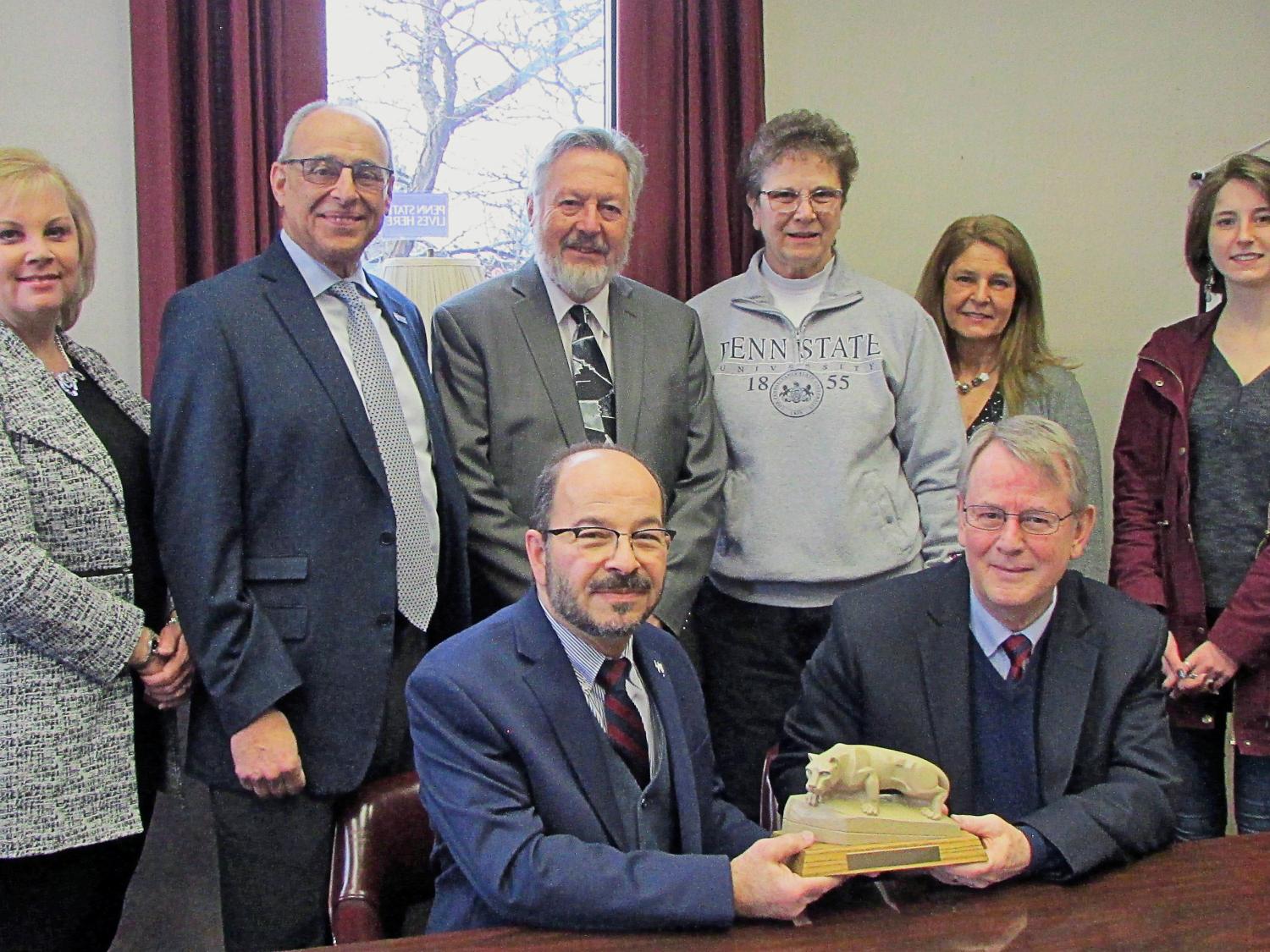 Dr. Wafa presents Schwartz Mack group with Nittany Lion statue