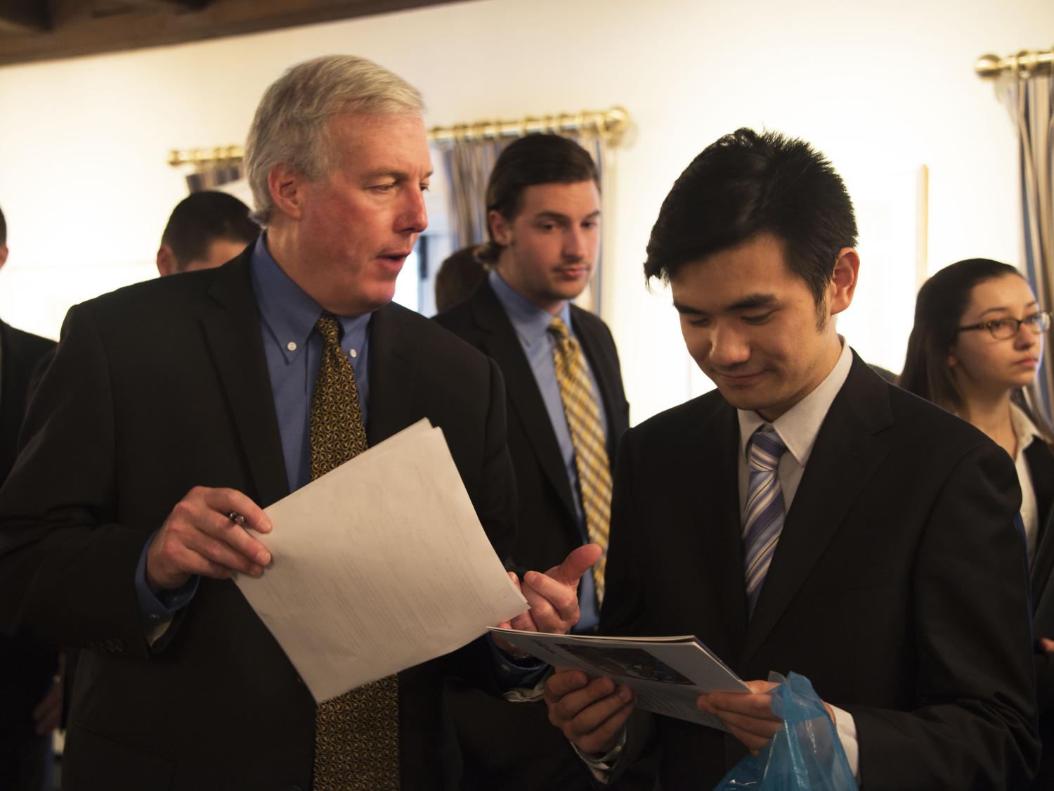 Students speaks with an industry professional at the College of Engineering Career Fair. 