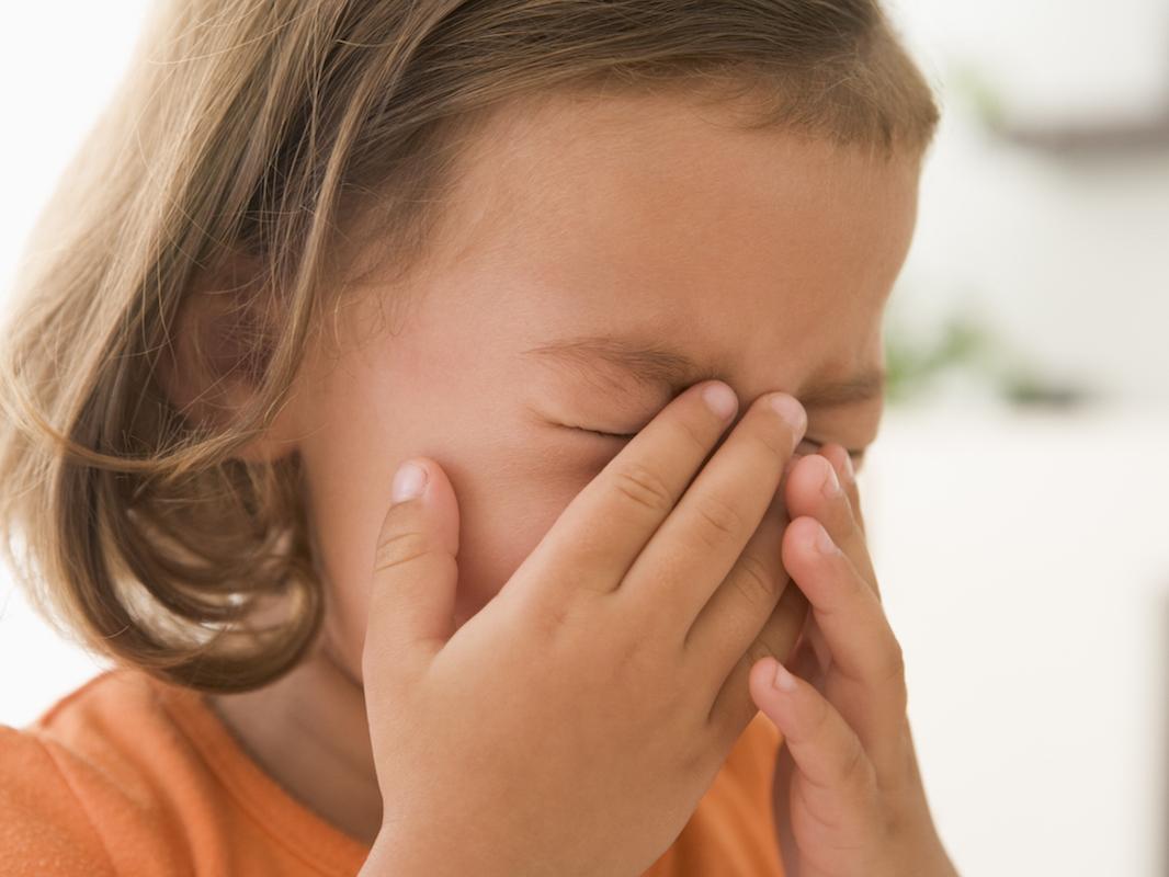 Young girl indoors crying