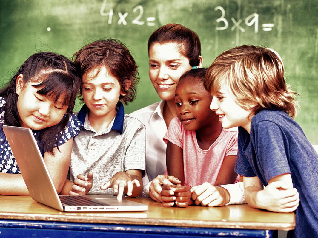 Happy children in a multi ethnic elementary classroom.