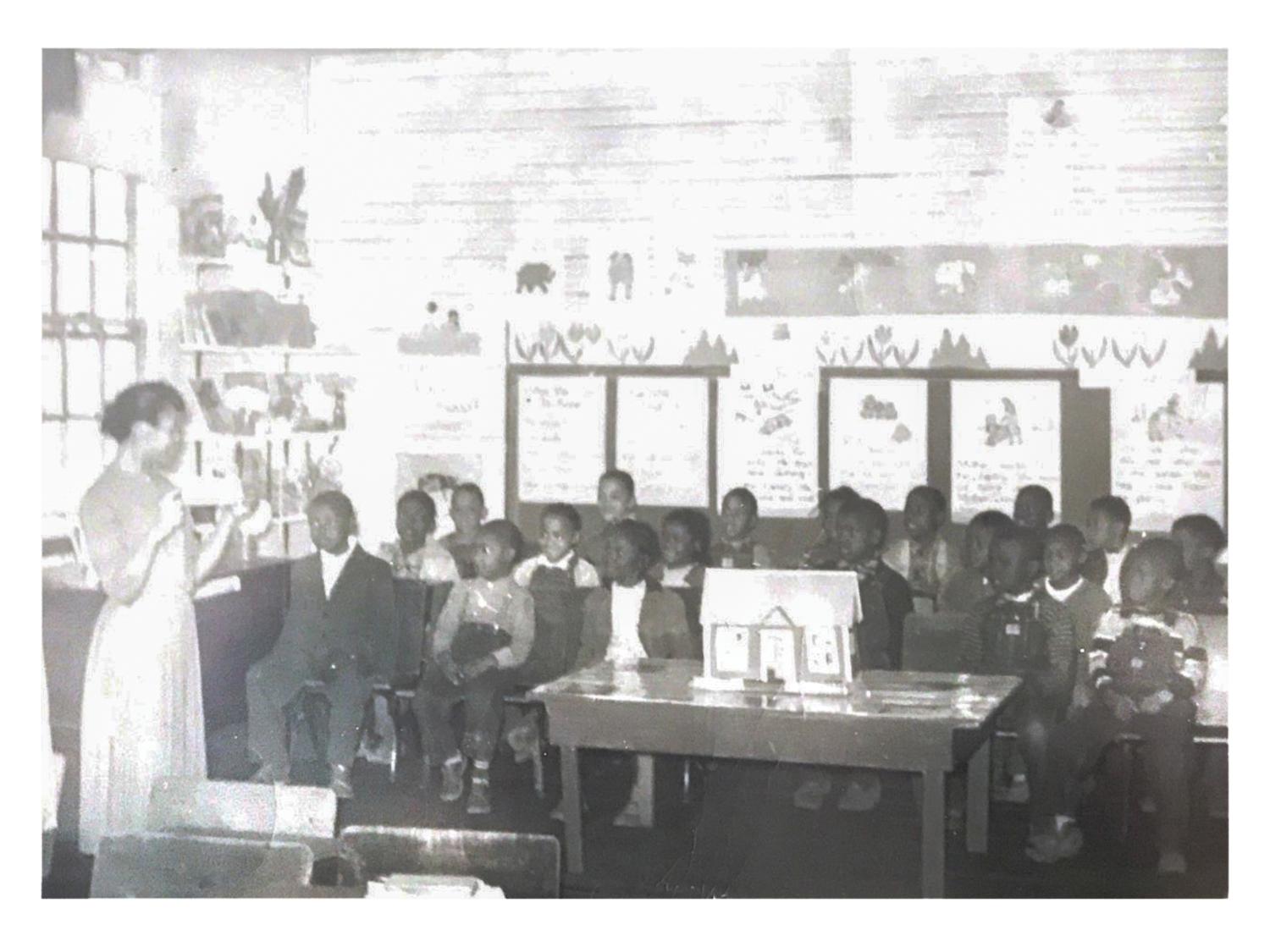 Helen Elizabeth Beasley with her students inside the two-room Rosenwald School where she taught.