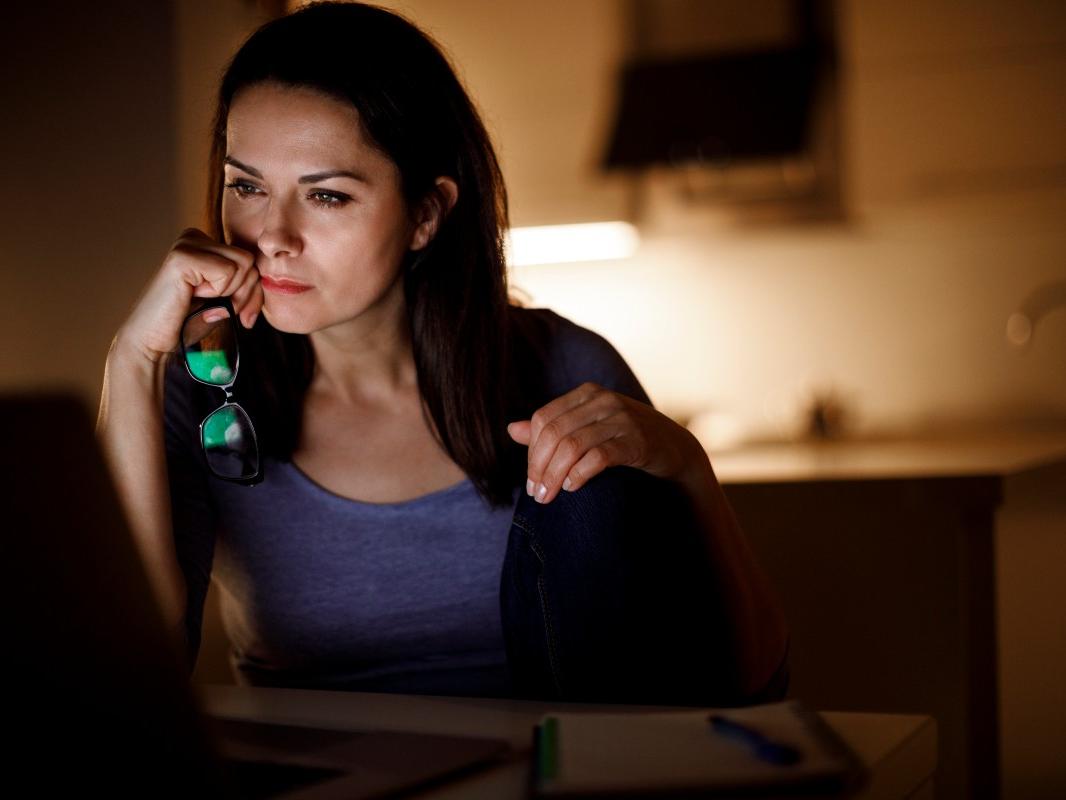 A woman looks at her computer