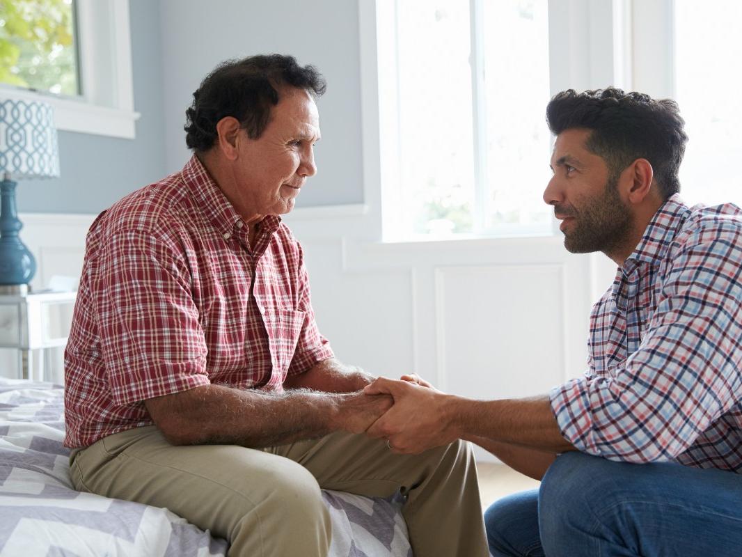 An adult son has an end of life care discussion with his elder father. 