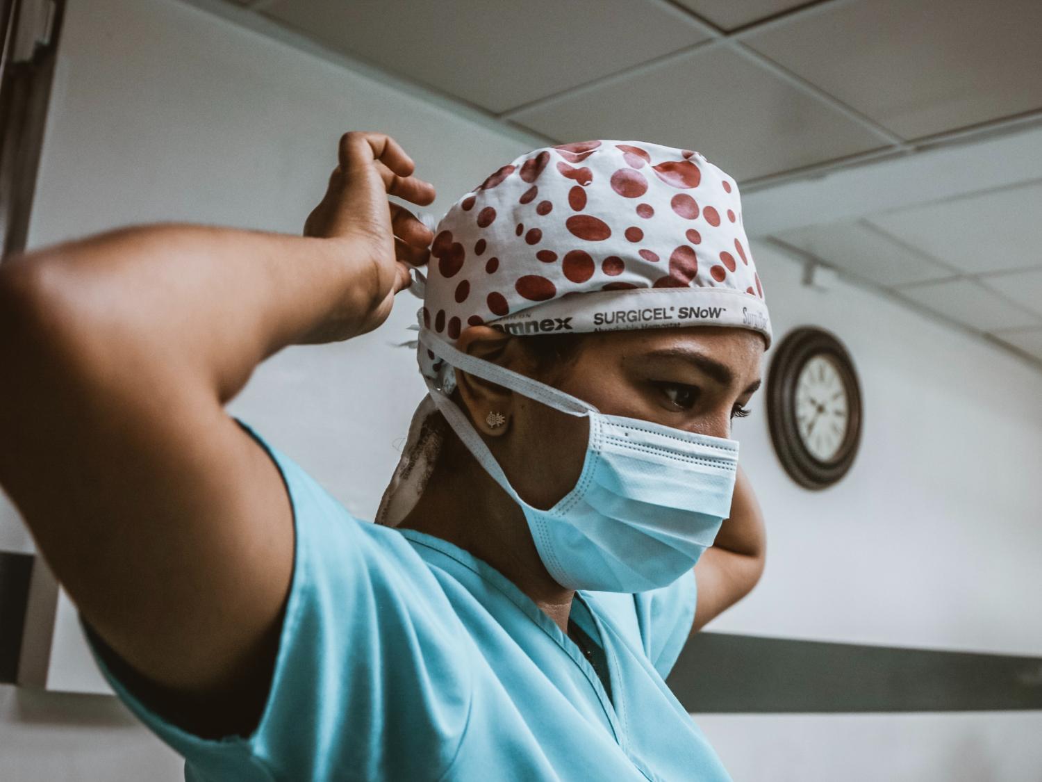 Nurse putting on mask