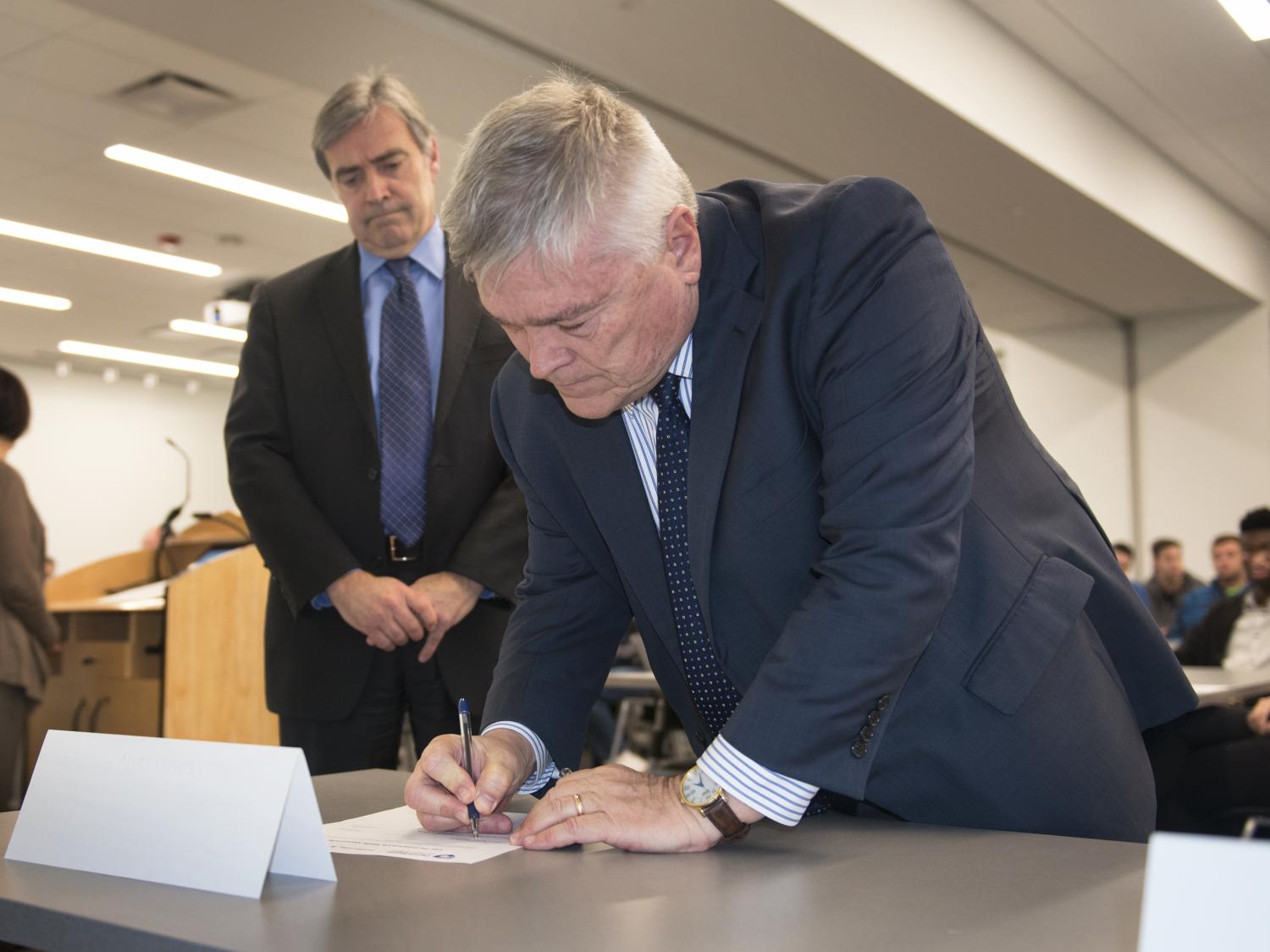 Penn State President Eric Barron signs the Greek-letter organization relationship statement.