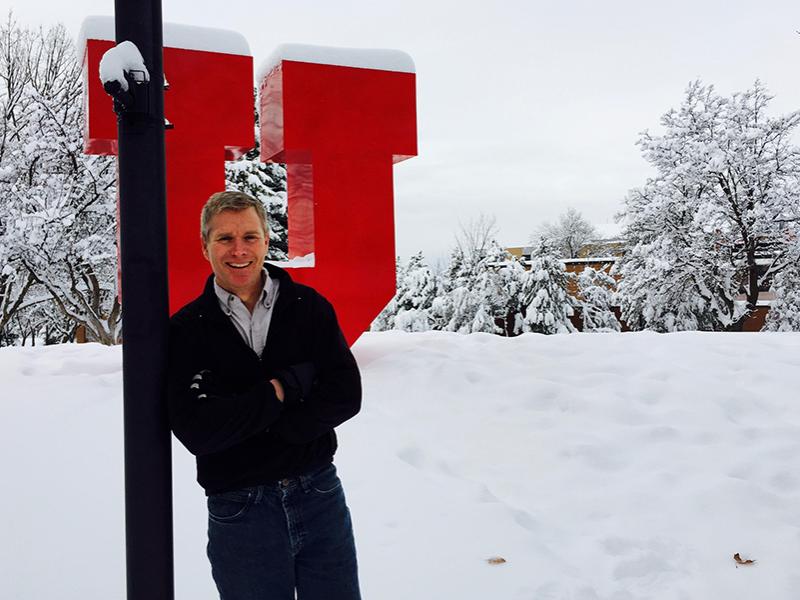 Jim Steenburgh standing next to University of Utah "U" statue