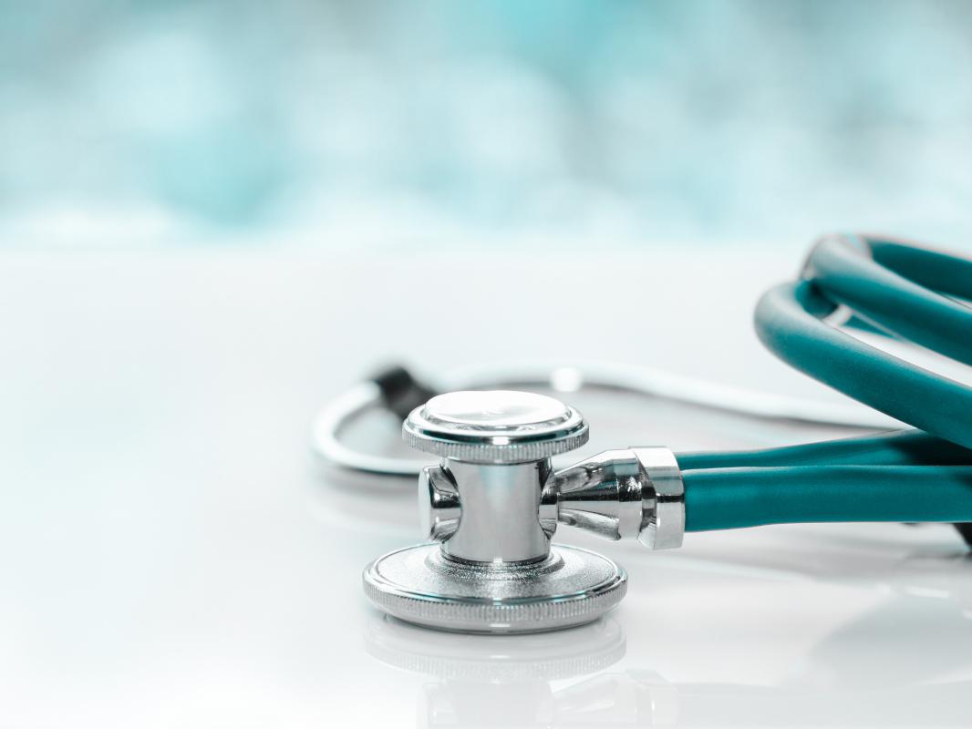 A close-up of a stethoscope on a desk.