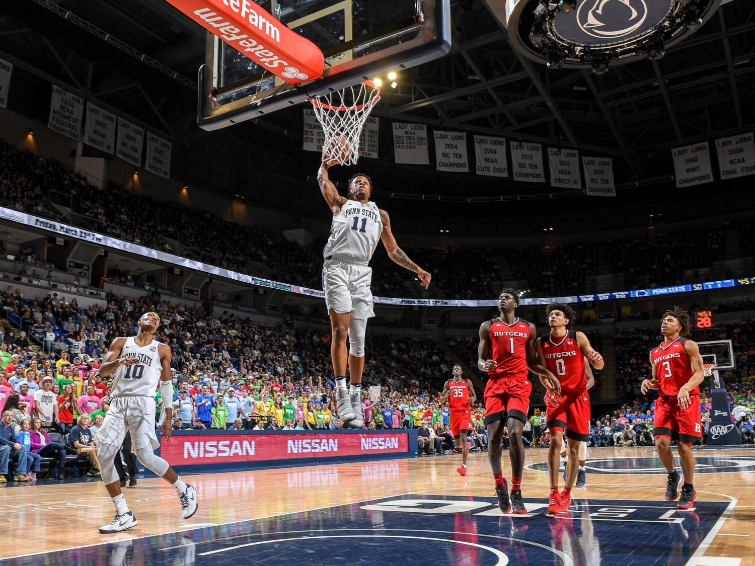 Man dunking basketball on a fast-break play